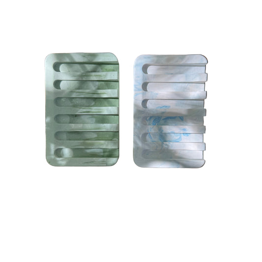 two cement soap dishes on white background