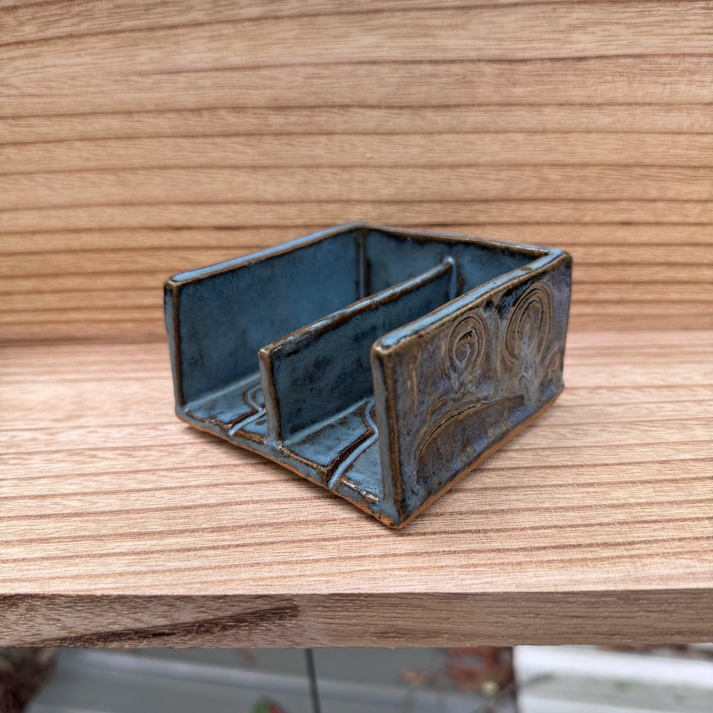 blue ceramic soap dish on wood background